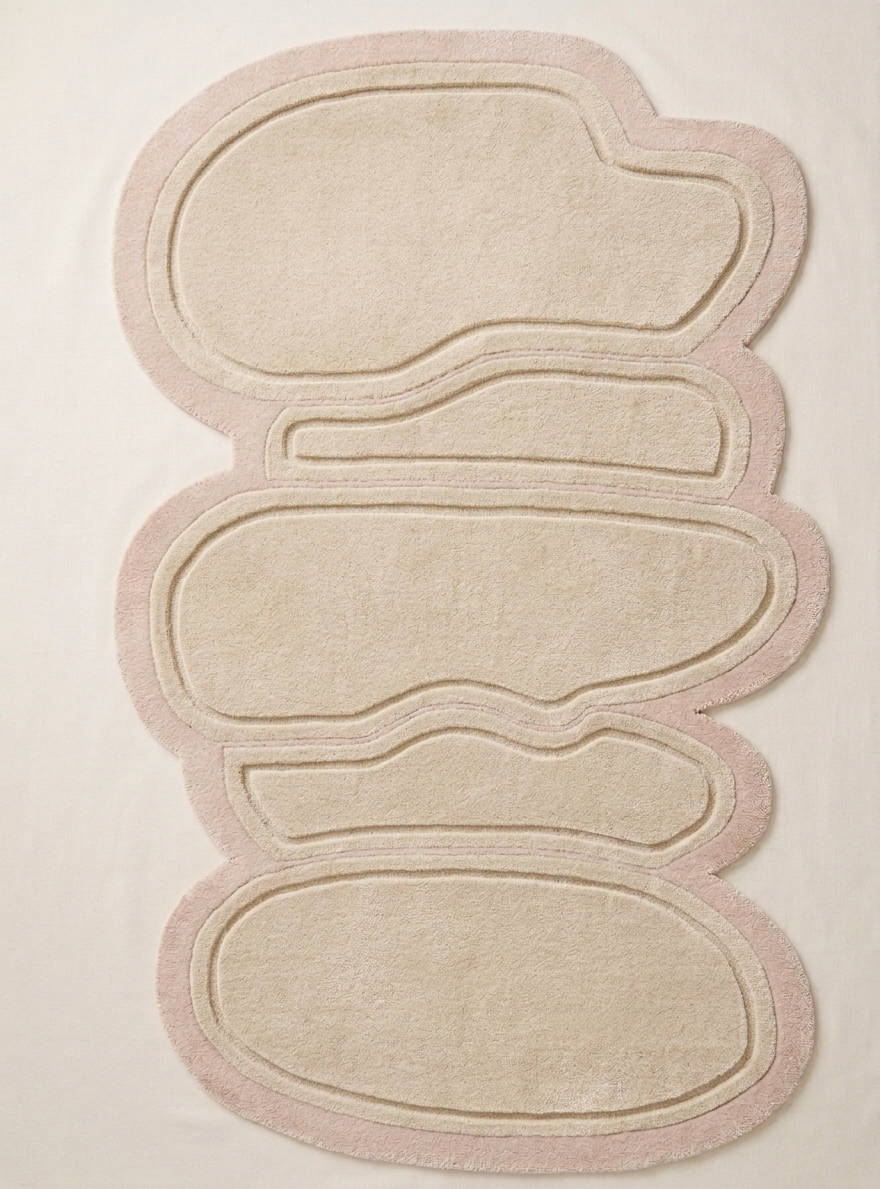 Beige rug with pink border on a light beige background