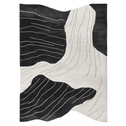 Black and white abstract patterned rug on a plain background